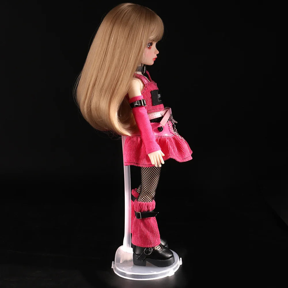 A pink doll wearing a red outfit and fishnet stockings is displayed on a clear stand.