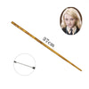 A long, slender gold-colored metal magic wand with decorative markings and a circular inset photo of a blonde woman.