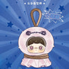 A cute, round vinyl plush blind box featuring a face with dark hair and pink cheeks, tied with a brown fabric clip.