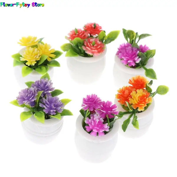 A collection of miniature green plant pots filled with colorful artificial flowers for dollhouse decor