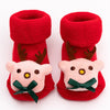 Pair of red baby anti-slip cotton socks with festive Christmas designs featuring reindeer and a bow.