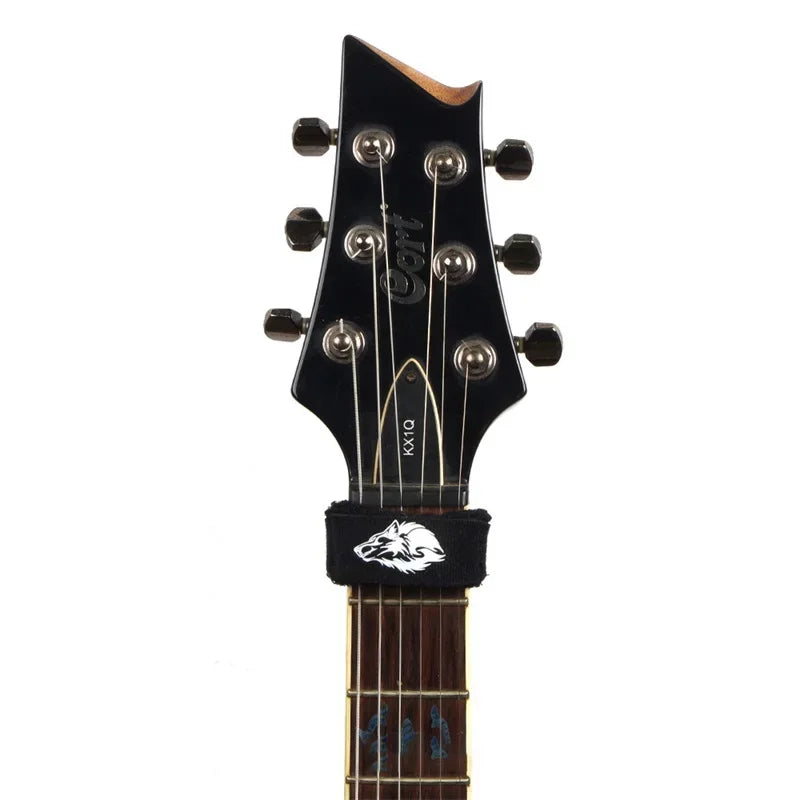 A black electric guitar neck featuring six strings and a custom wolf head inlays.
