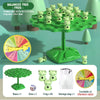 A green plastic tree structure with small frog figures on branches, along with dice and a storage bag.