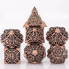 A set of seven intricately detailed metal dice featuring skull and dragon designs in a bronze color.