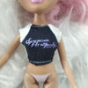 A doll fashion set featuring a light skin tone, pink hair, and a black top with white trim.