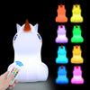 A white koala LED night light is shown with its remote control and multiple colored light options.