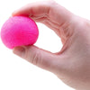 A hand is holding a bright pink, textured fuzz ball sensory toy.