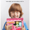 A child holds a pink and yellow twist surprise toy for kids with cute patterns.