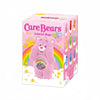 A pink Care Bear figurine with a rainbow belly is shown in its POP MART packaging.
