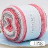 Roll of gradient rainbow yarn with red, white, and gray stripes for knitting and crochet