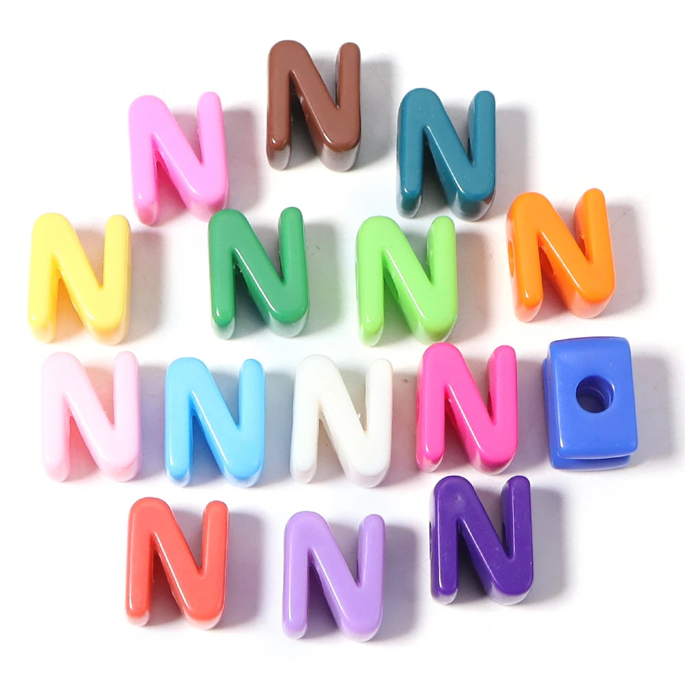 A collection of colorful acrylic letter N beads arranged in a star shape.