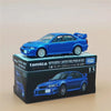 A blue Mitsubishi Lancer Evolution VI GSR die-cast model car displayed on its packaging box.