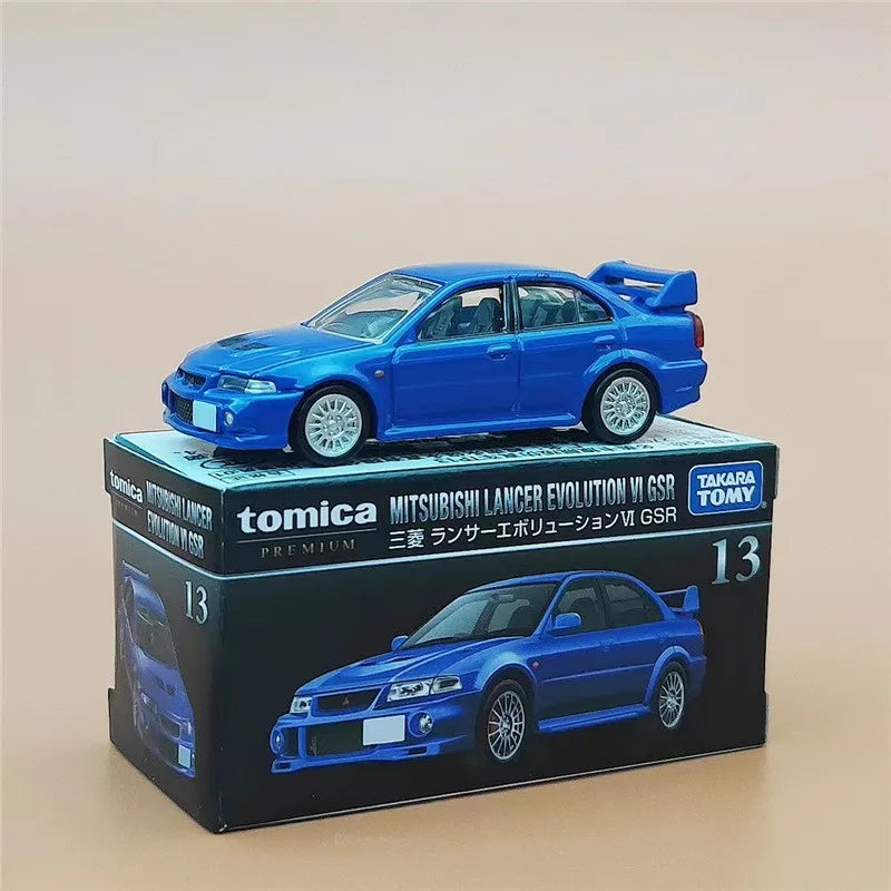A blue Mitsubishi Lancer Evolution VI GSR die-cast model car displayed on its packaging box.