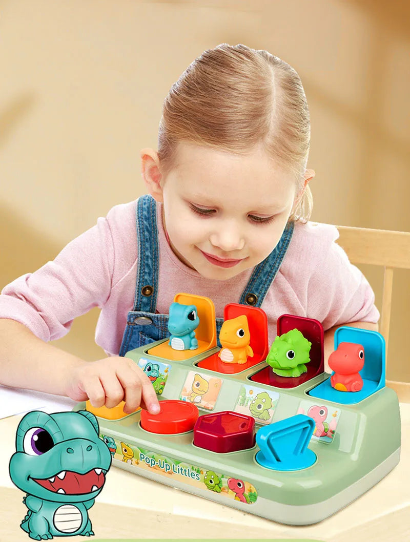 A young girl plays with a green pop-up animal toy featuring various colorful animals and Montessori learning elements.