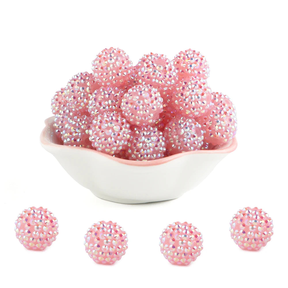A pile of pink rhinestone resin bayberry beads for jewelry making