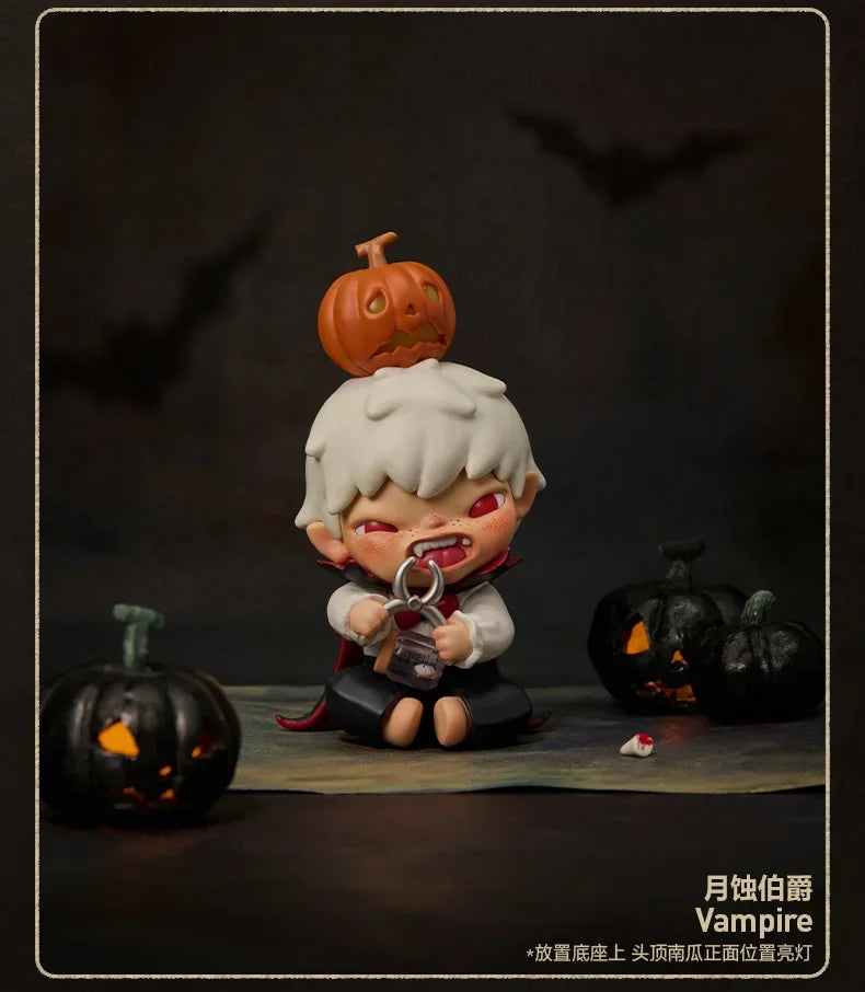 A collectible figure of a small monster with orange skin and white hair, sitting in front of a black pumpkin.