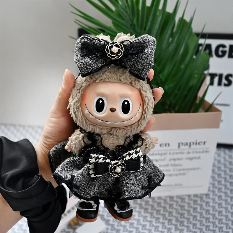 A handmade flannel outfit for a 17cm Labubu doll featuring black and gray fabric with a floral bow.
