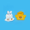 A white rabbit plush toy and a yellow hoodie with gold chain accessories.