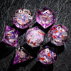 A collection of eight translucent purple resin dice with galaxy sharp edge patterns displayed on a dark surface.