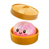A set of two squishy toys, including a yellow lid and a pink glitter dumpling-shaped squishy toy.