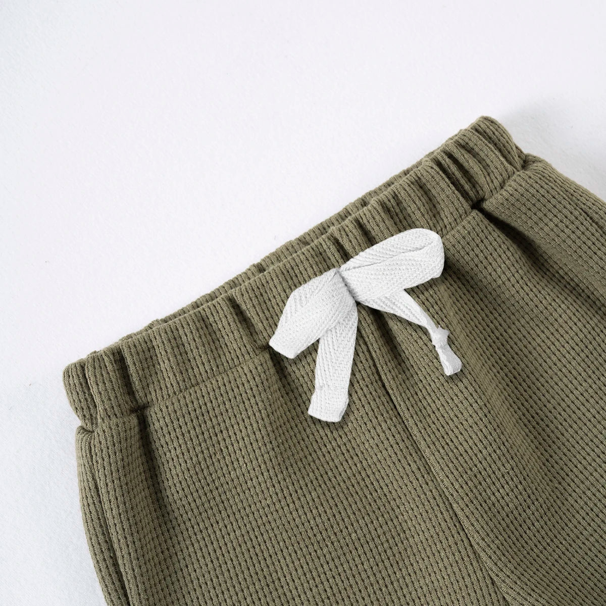Olive green knit shorts with a white tie detail