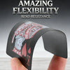 A hand holds a black plastic playing card deck demonstrating amazing flexibility and bend resistance.