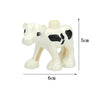 A white plastic zoo animal building block shaped like a calf or young bovine.