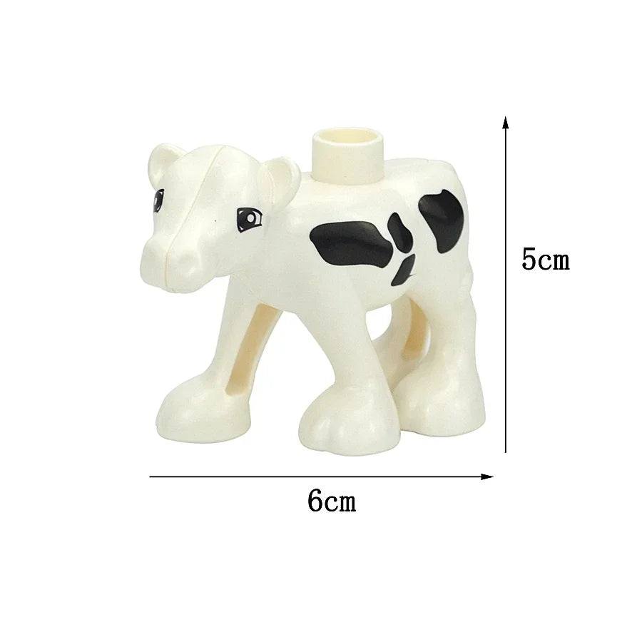 A white plastic zoo animal building block shaped like a calf or young bovine.