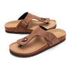 A pair of brown suede cork mules with arch support shown from the side.