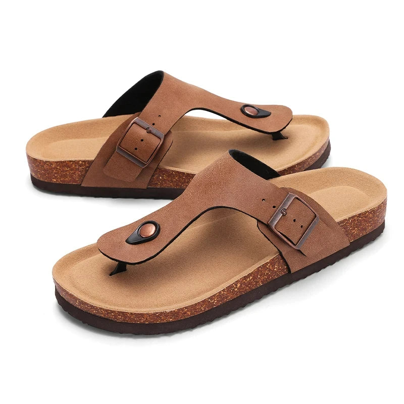 A pair of brown suede cork mules with arch support shown from the side.