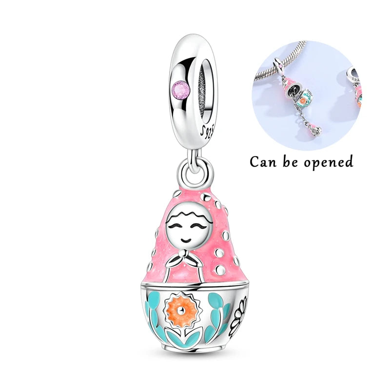 Silver heart charm bead with pink zircon and a dangle charm, designed to be opened.