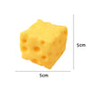 A yellow, cube-shaped cheese squishy fidget toy with visible holes, shown from the top and side.