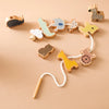 A set of wooden animals used for threading and stacking toys in various colors like yellow, green, and brown.