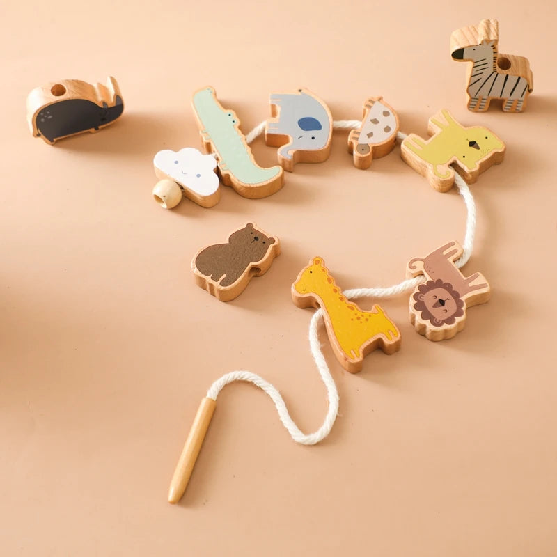 A set of wooden animals used for threading and stacking toys in various colors like yellow, green, and brown.