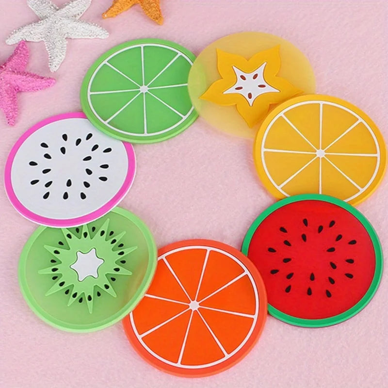 A colorful set of fruit pattern PVC coasters featuring lime, lemon, orange, and watermelon designs.
