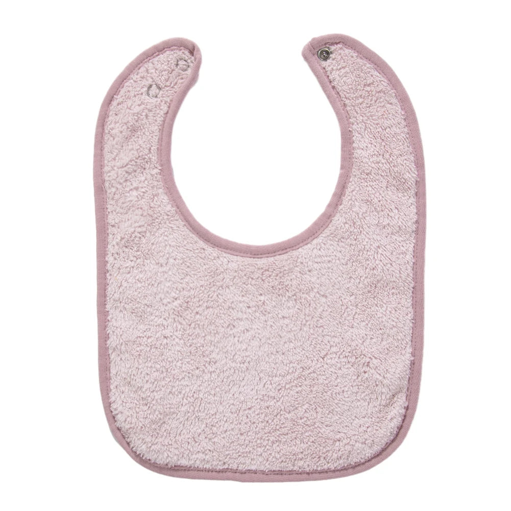 A light pink soft cotton baby bib with a U-shaped opening and adjustable snap closure.