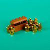 A wooden treasure chest is open, filled with gold and silver building blocks.