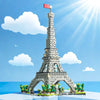 An LED-illuminated model of the Eiffel Tower built from micro building blocks against a bright blue sky.