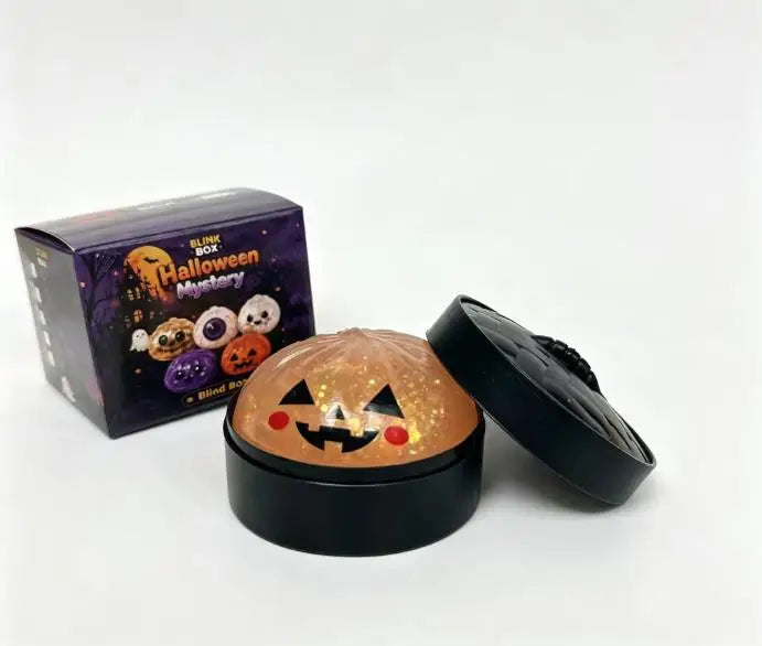 A black tin of Halloween-themed squishy stress relief toy with a glowing orange face design.