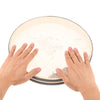 Hands holding a 12-inch ocean drum with a hardwood shell and carry bag