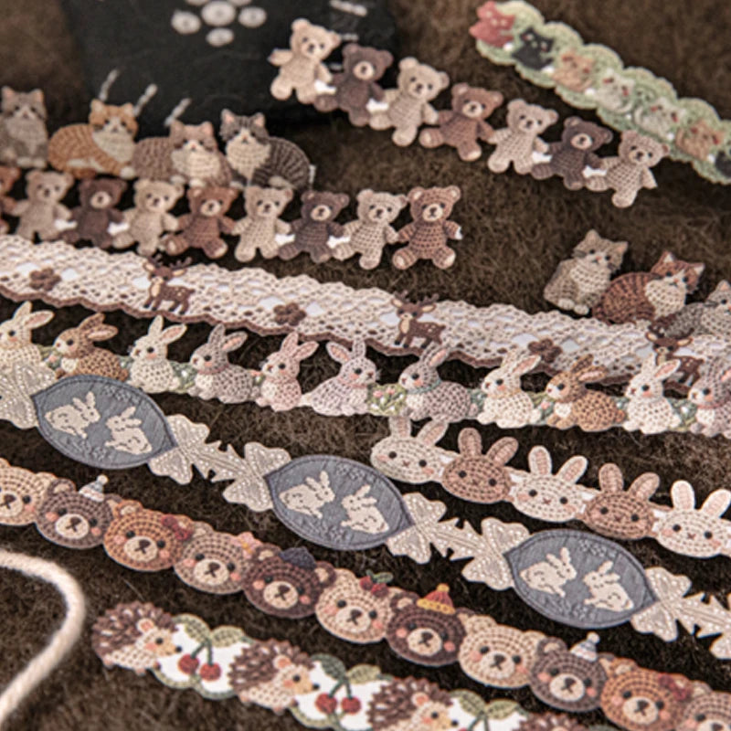 A collection of fabric-textured sticker strips featuring small, cute animal figures in various earthy tones.