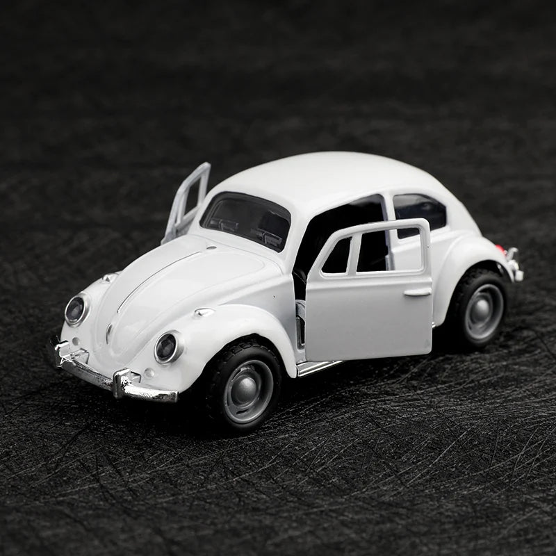 A white 1:38 die-cast model of a classic Beetle car shown from the side.
