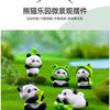 A set of adorable resin panda figurines in various poses and colors displayed on green grass.