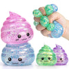 A hand holds a pink glitter squishy stress ball and a small green glitter squishy fidget toy.
