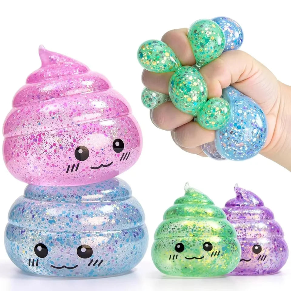 A hand holds a pink glitter squishy stress ball and a small green glitter squishy fidget toy.