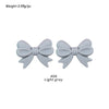 Two light gray silicone bow tie beads for jewelry making and craft projects