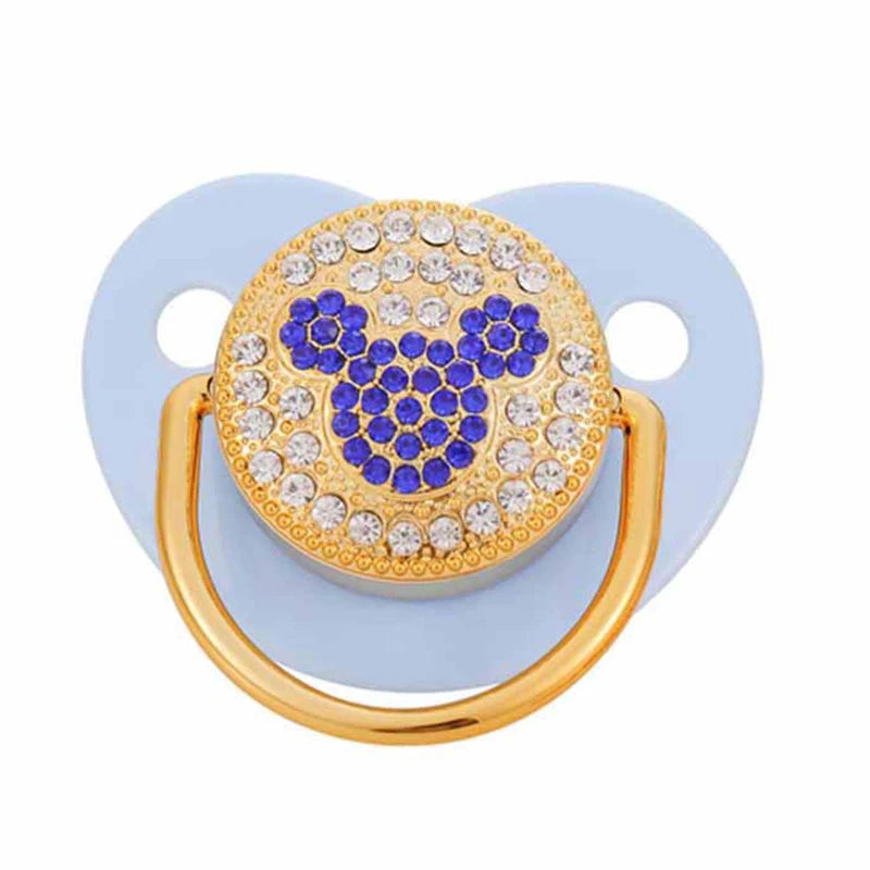 Rose gold crystal bling pacifier with a gold ring and light blue silicone base