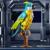 A yellow and teal mechanical dragonfly model kit standing on a display base.