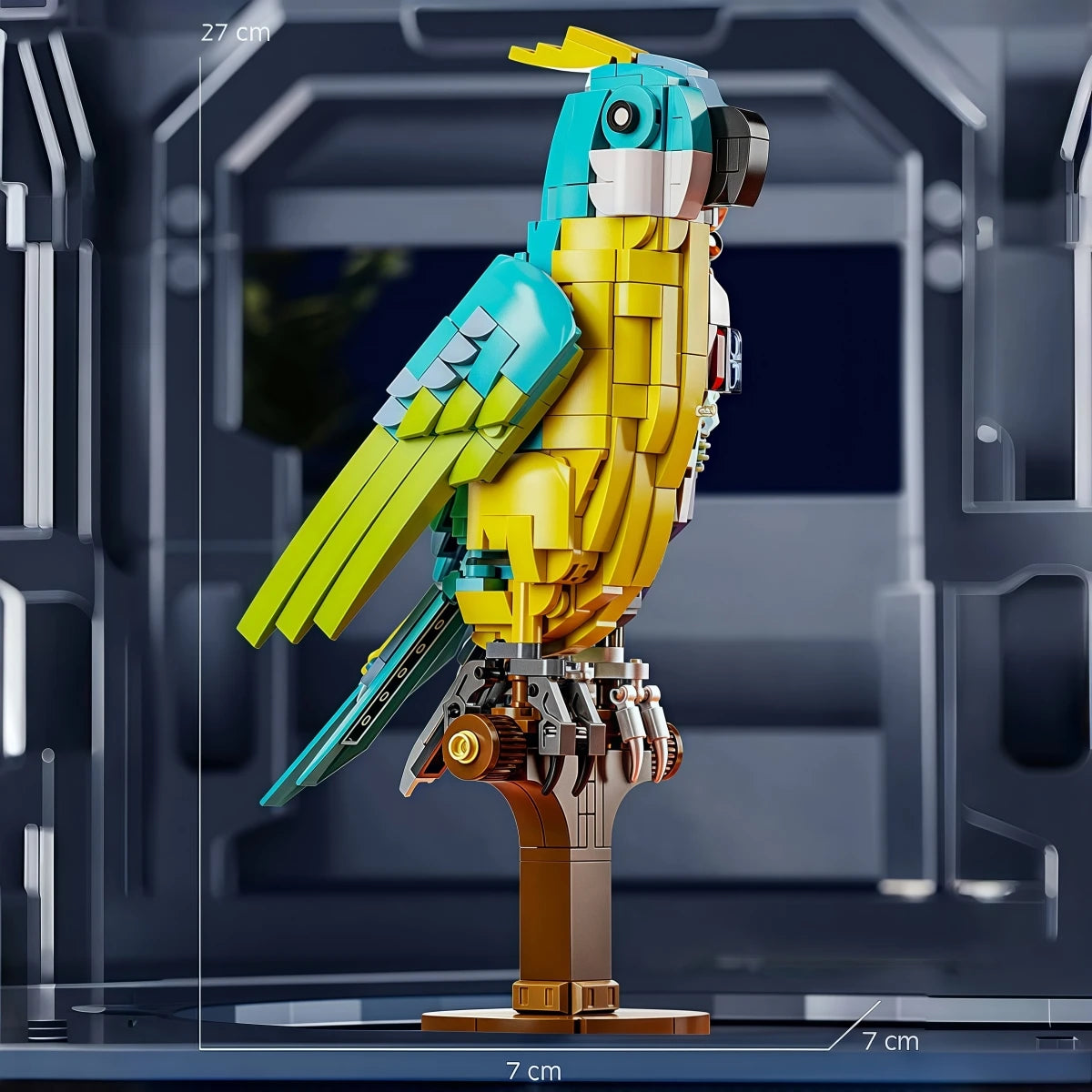 A yellow and teal mechanical dragonfly model kit standing on a display base.