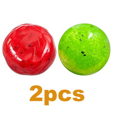 Two spherical slime squishies, one red like watermelon and one green like kiwi.
